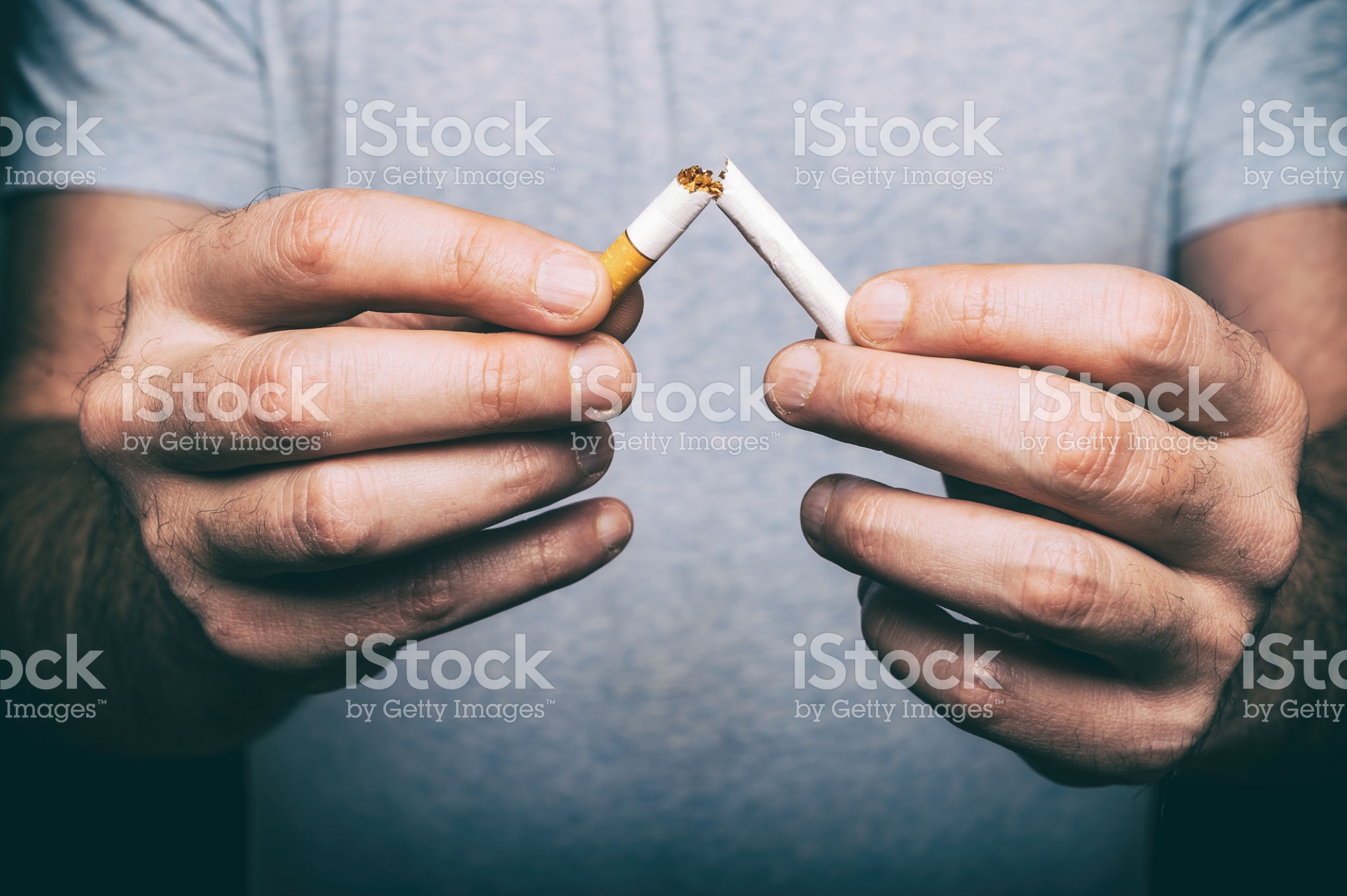 Quitting smoking – male hand crushing cigarette